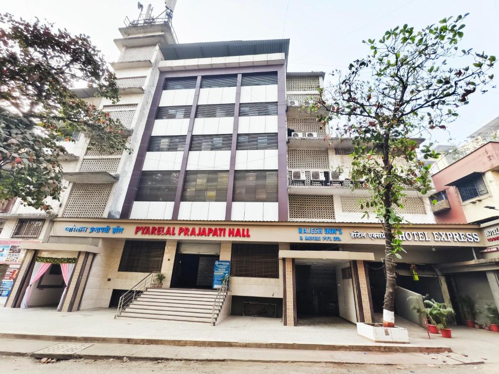 a tall building with a clock on top of it at Hotel Express Airoli in Navi Mumbai