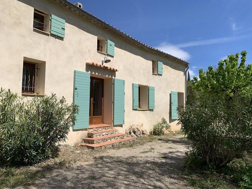 a house with blue shutters and a door at Mas de la clue - 4 personnes in Figanières
