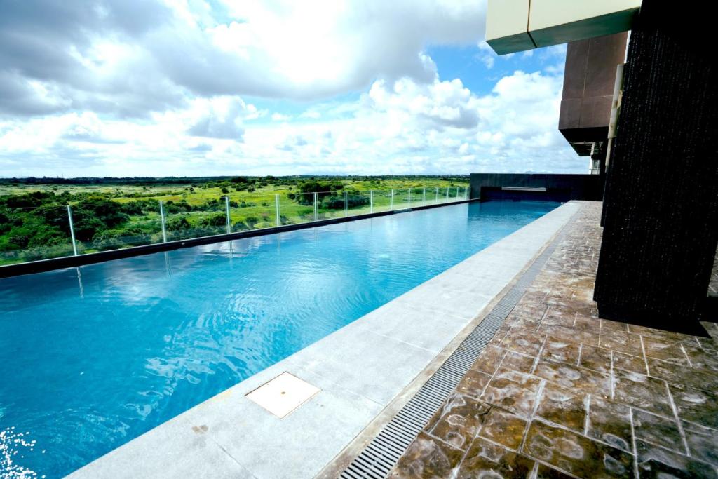a view of a swimming pool in a building at Elijah Hotel Dasmarinas City Cavite in Dasmariñas