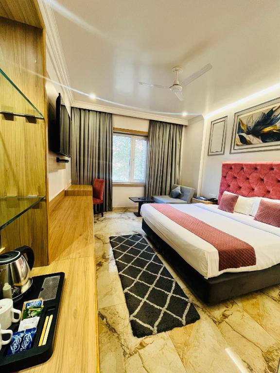 a hotel room with a bed and a television at Hotel Airport Centre Point in Nagpur