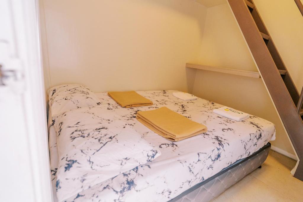 a small room with a bed with two blankets at Serenity Busay Room 1 in Cebu City