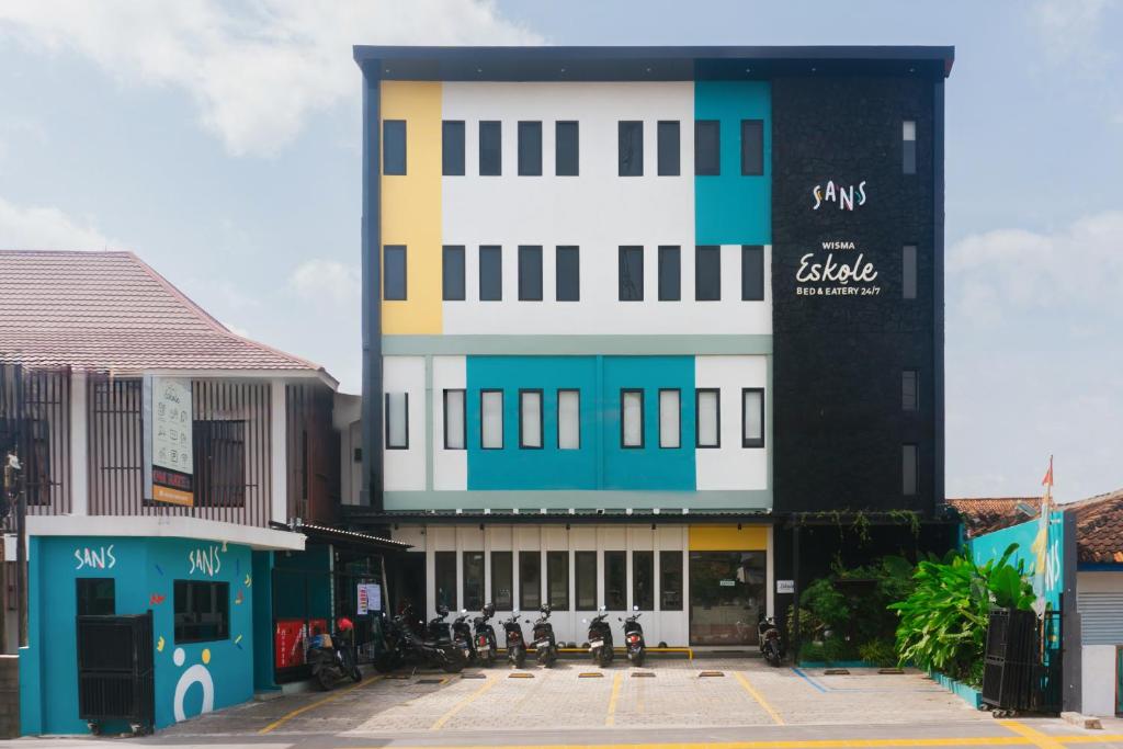 a large building with blue and white at Sans Stay Eskole Lampung in Geruntang