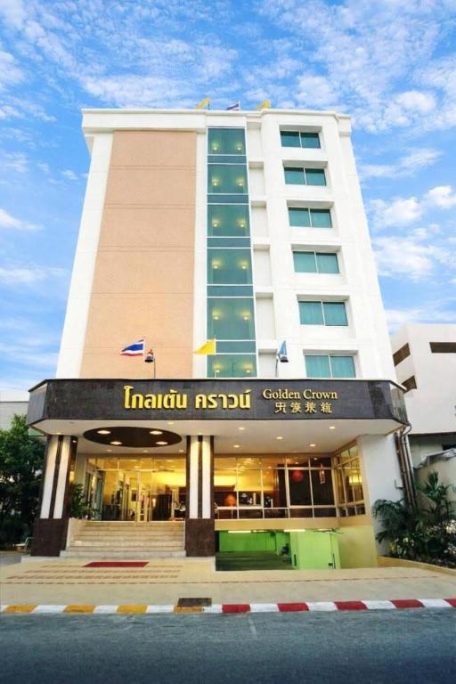 a hotel building with a sign in front of it at Hatyai Golden Crown Hotel in Hat Yai