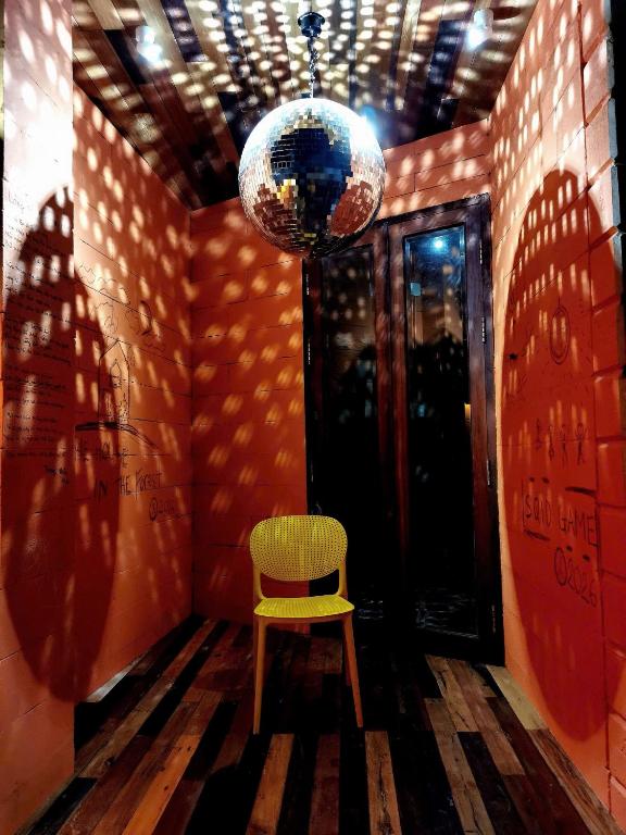 a room with a chair and a disco ball at Hong Ly House in Vĩnh Hy