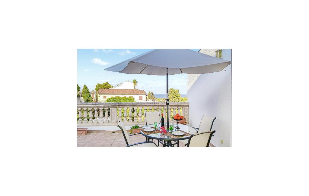 a patio with a table and an umbrella at La Esperanza in Capdepera