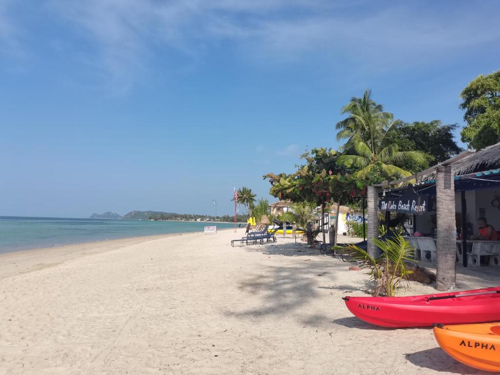 a beach with two boats on the sand at The Relax Resort in Ko Phangan