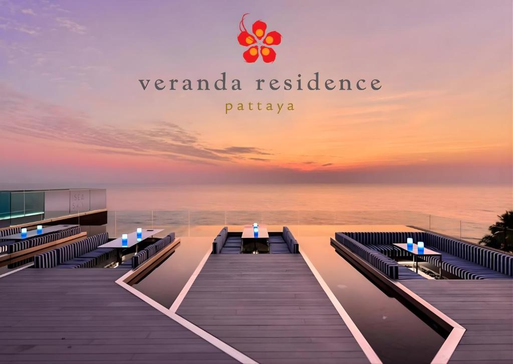 a restaurant with a view of the ocean at sunset at Large 3BR Veranda Pattaya Direct Beach Access in Jomtien Beach