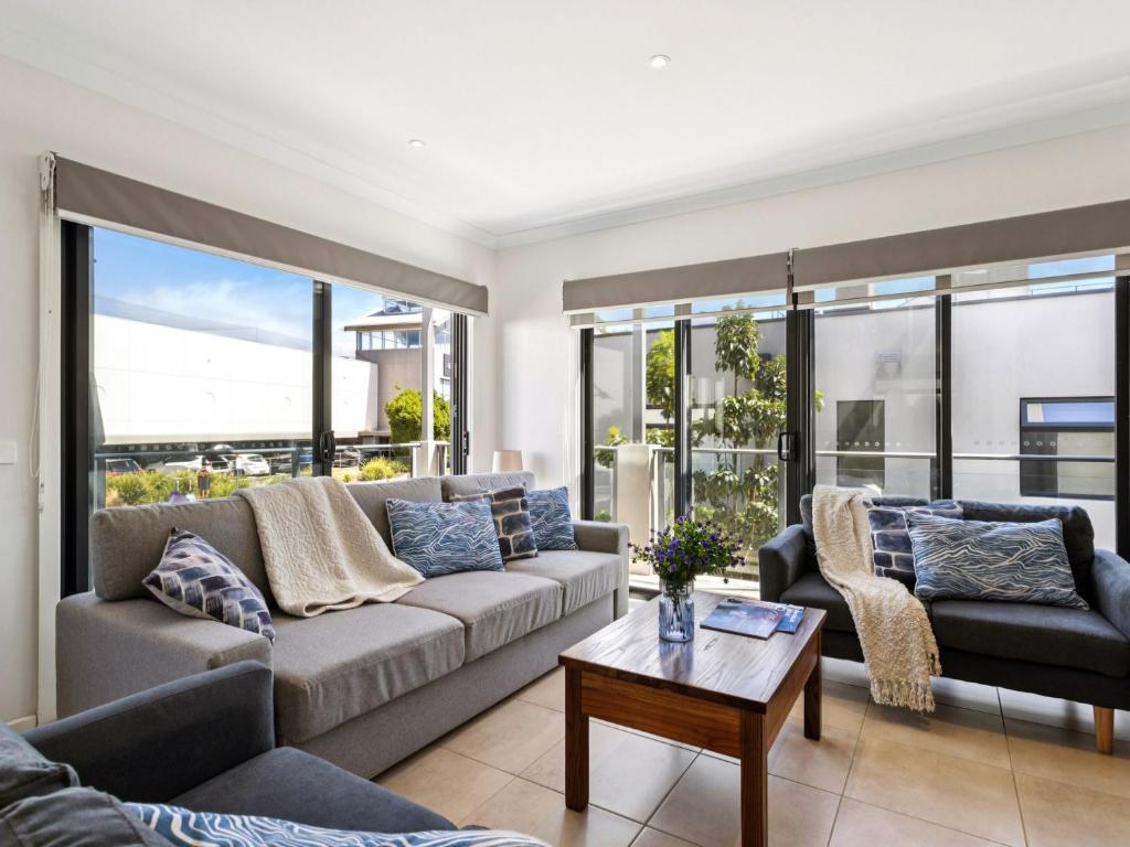 a living room with a couch and a table at Azura on Gordon in Mornington