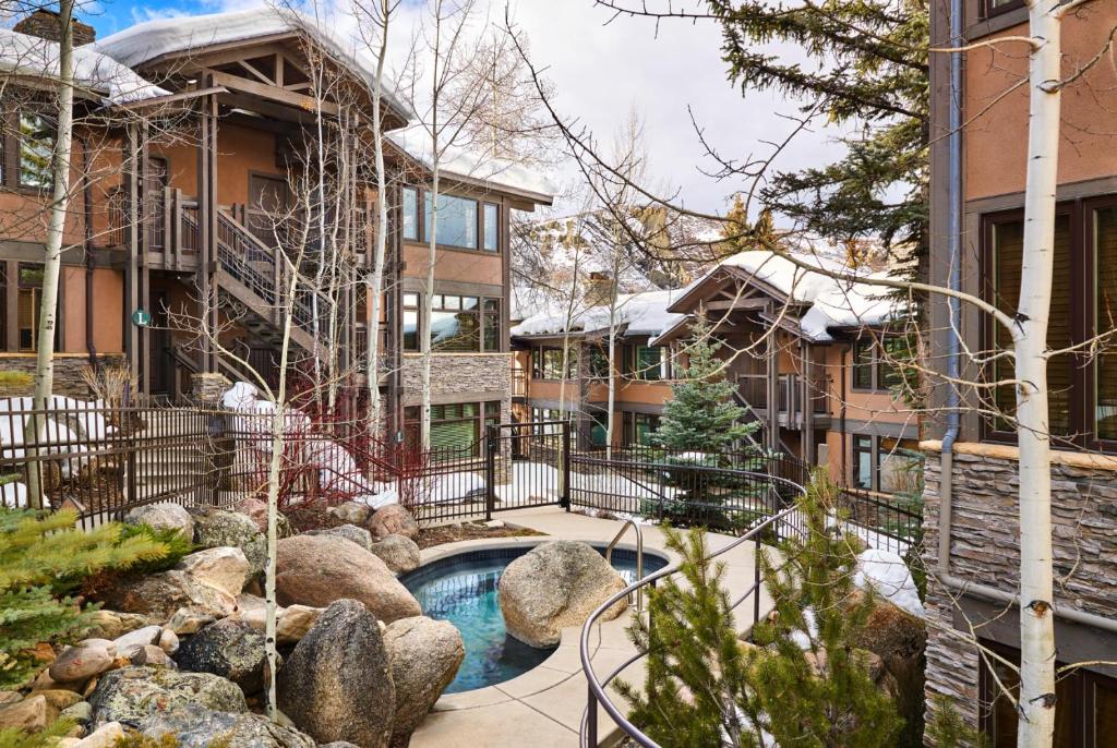 a house with a swimming pool in the yard at Aspenwood - CoralTree Residence Collection in Snowmass Village