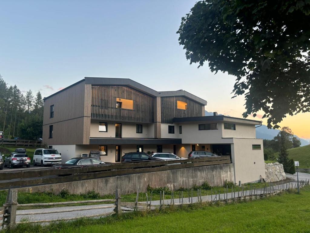 a building with cars parked in a parking lot at SOLU Apartments in Seefeld in Tirol