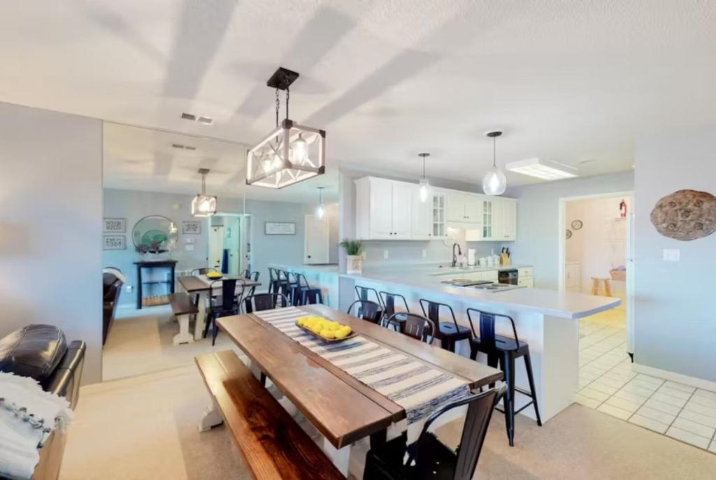 a kitchen and living room with a wooden table and chairs at Pointe Royale's Relaxation Pointe in Branson