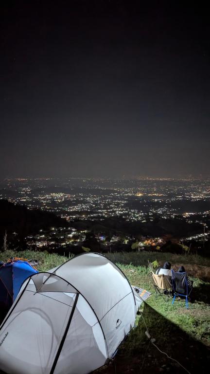 a group of tents on top of a hill with a city at Go Camp in Kemuning
