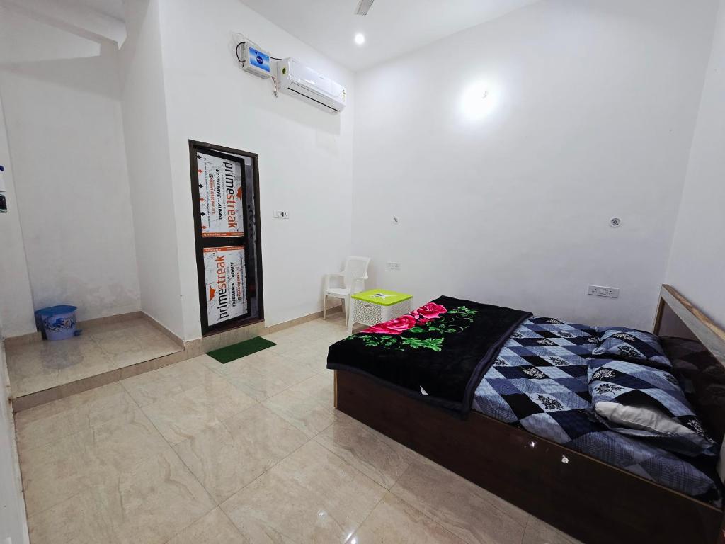 a bedroom with a bed with flowers on it at Parth Guest House in Ayodhya
