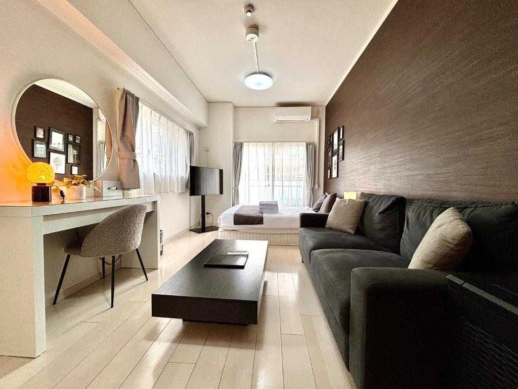 a living room with a couch and a table at Lion Heiwa Odori in Hiroshima