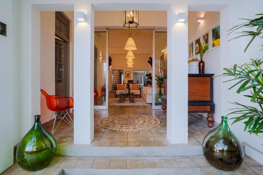 a hallway with two green glass vases on the floor at Eklektik in Colombo