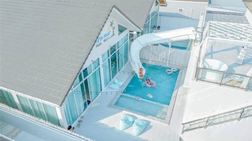 an overhead view of a woman in a swimming pool at Chern Mar Pool Villa Cha-am in Cha Am
