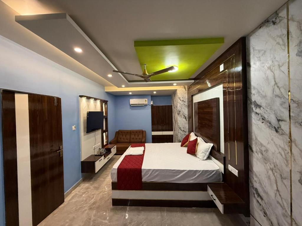 a bedroom with a bed with a green ceiling at erode kongu mess in Chennai