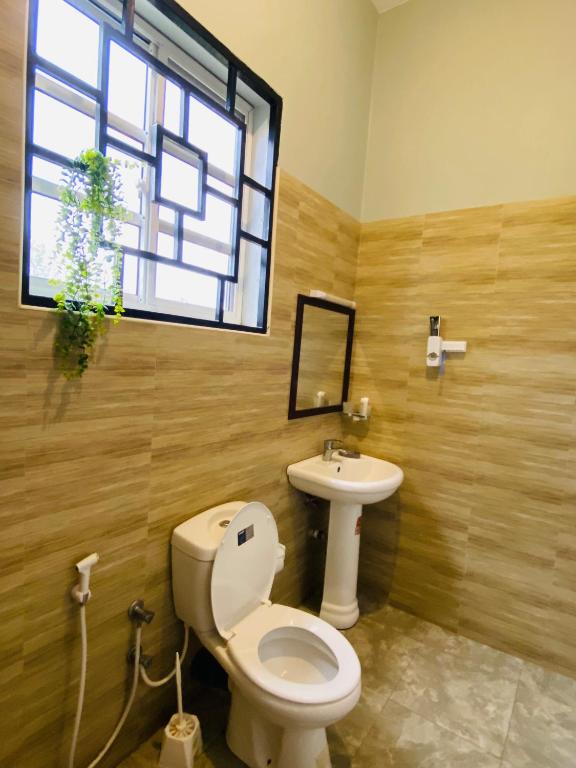 a bathroom with a toilet and a sink at Tulivu Nyumba in Arusha