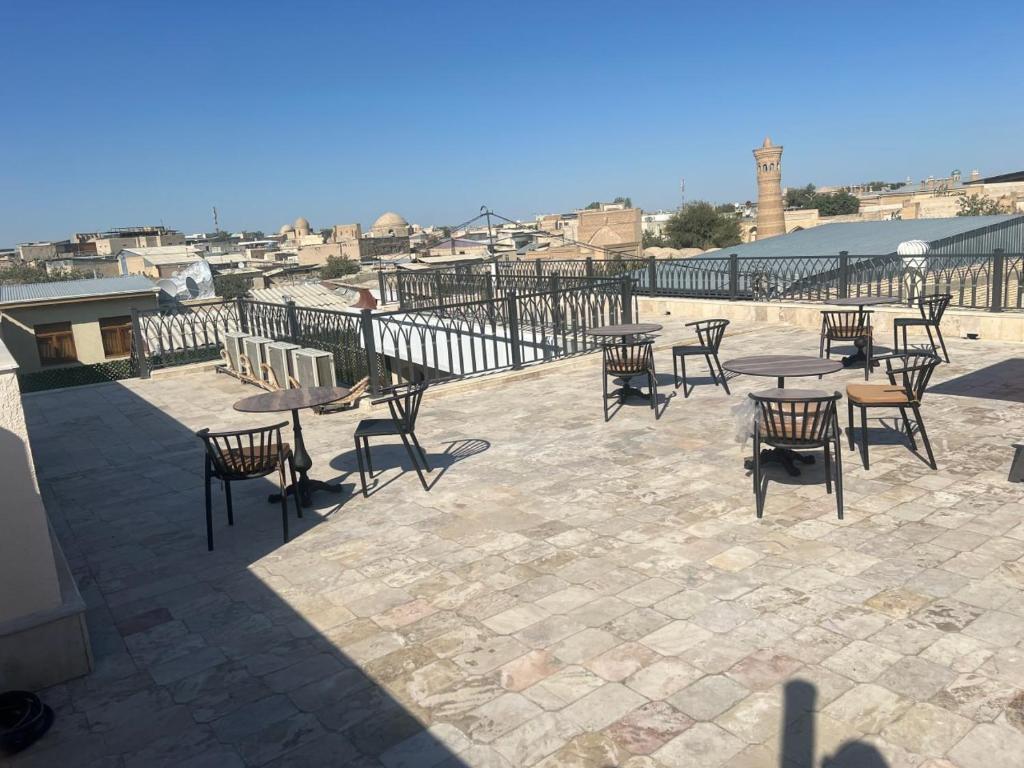 a group of tables and chairs on a patio at Abu Zarr Terrace in Bukhara