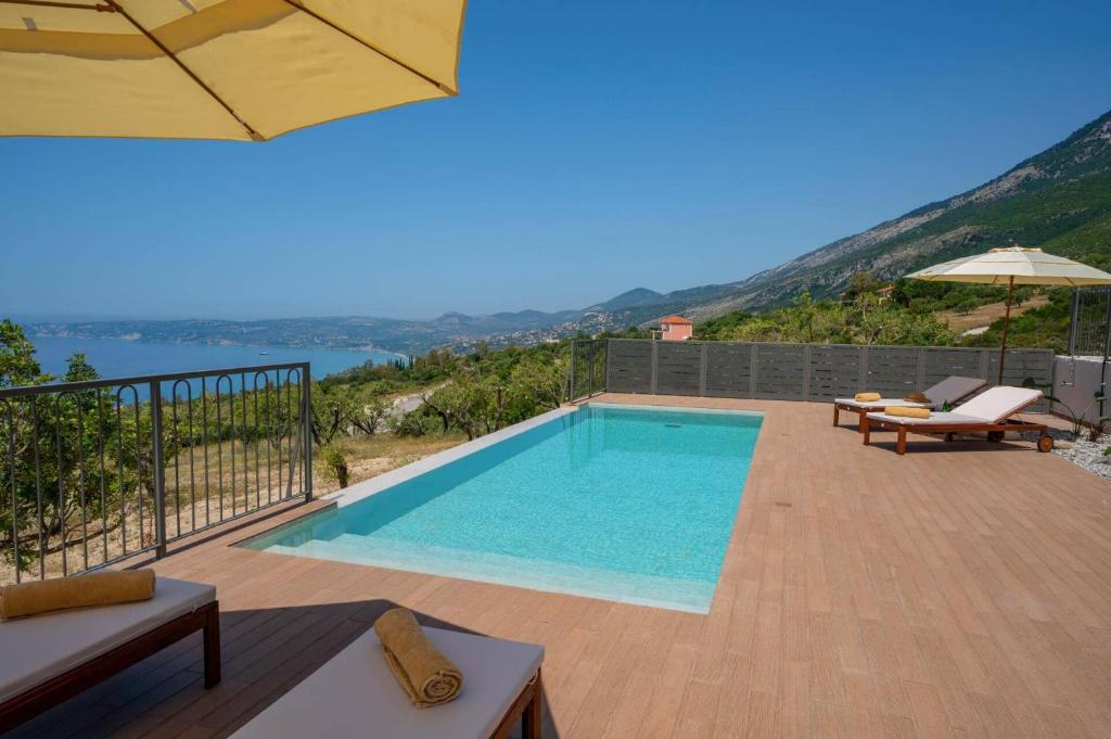 a swimming pool with a view of the water at Villa Katoikia Dio by Villa Plus in Simotáta