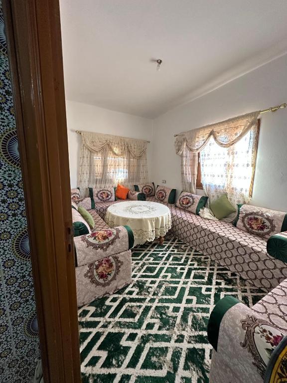a living room with a couch and a table at Villa ben lahbib in Khenifra