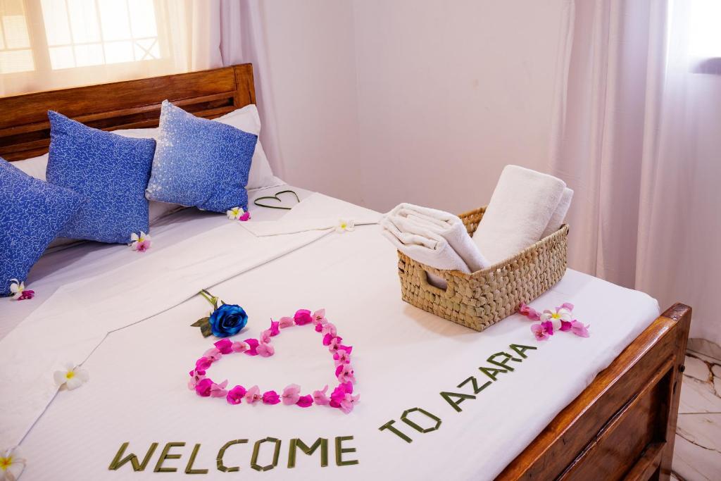 a bed with a welcome to navaho sign on it at Azara Watamu in Watamu