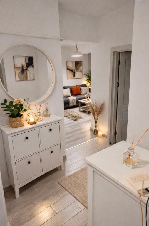 a living room with a white dresser and a mirror at Iulius Mall New Residence in Iaşi