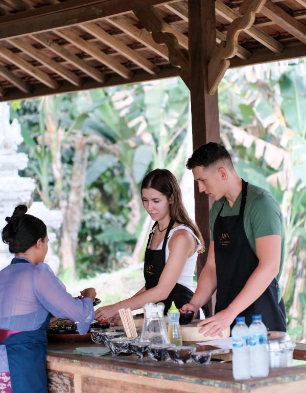 a group of people preparing food at a table at Lembu Putih House in Tegalalang