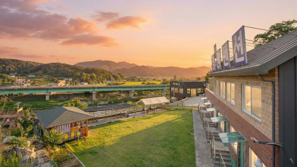 an aerial view of a building with a view of a river at Gapyoeng New Cheongpyeong Pension in Gapyeong