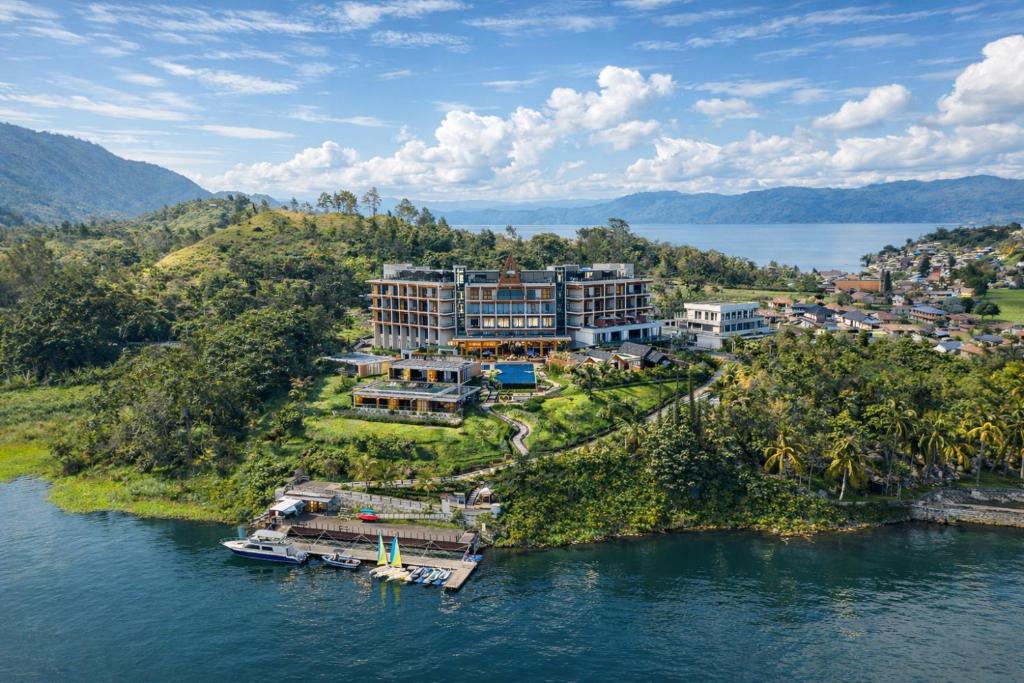 an aerial view of a resort on a island in the water at Marianna Resort And Convention Tuktuk - Samosir, Marclan Collection in Tuktuk Siadong