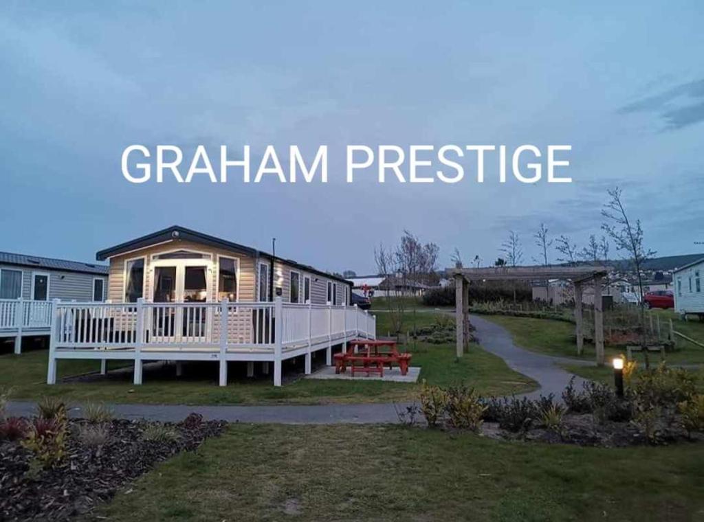 a cabin in the middle of a yard at Grahams Prestige Craig Tara in Minishant