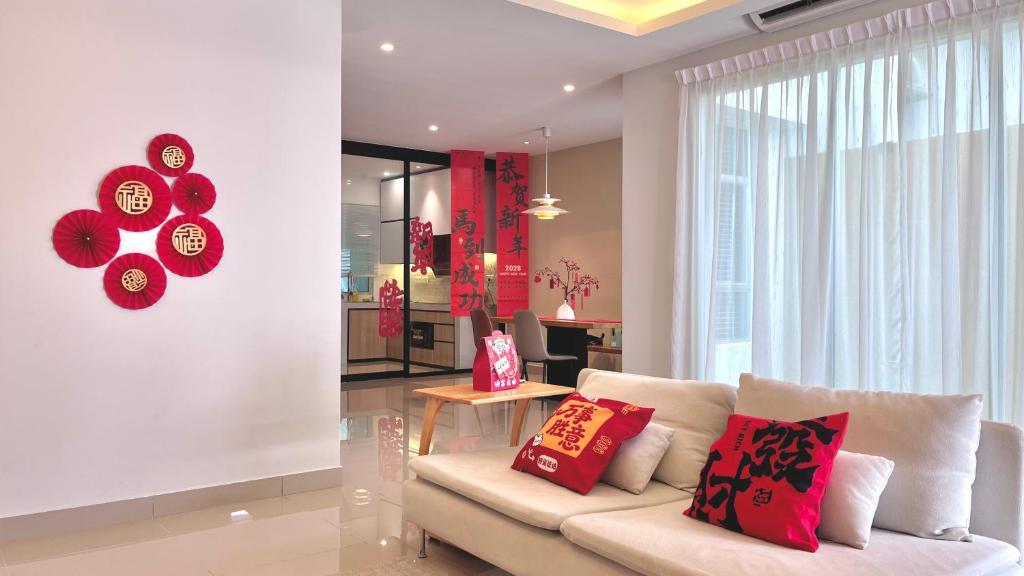 a living room with a white couch with red pillows at Ayera Residence Muji X Near Permas X Staycation 4BR4B #12 pax by Cowidea in Masai