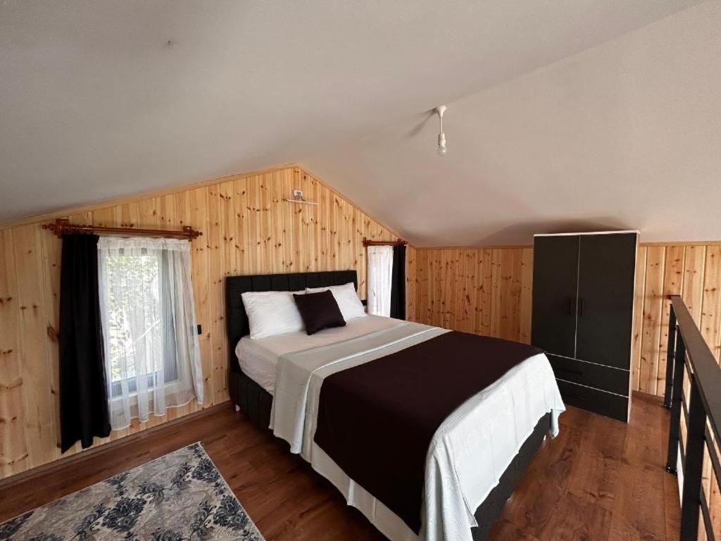 a bedroom with a large bed and a window at Mavi Apart in Demre