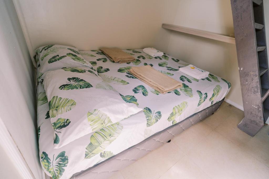 a small bed in a corner of a room at Serenity Busay Room 2 in Cebu City