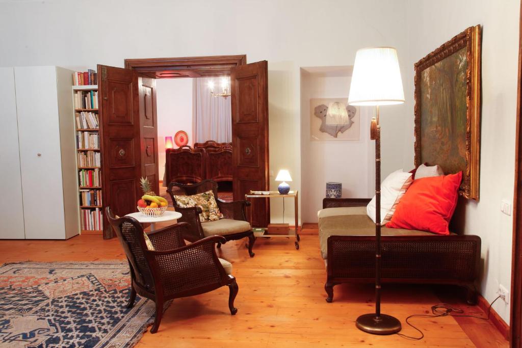 a living room with a bed and a table and chairs at Schloss Unterloibl in Ferlach