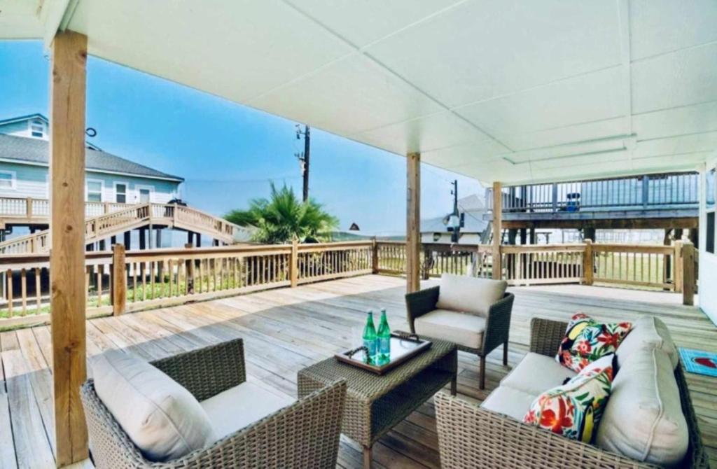 a patio with a couch and chairs on a deck at Bailey Beach House Beach Views in Freeport