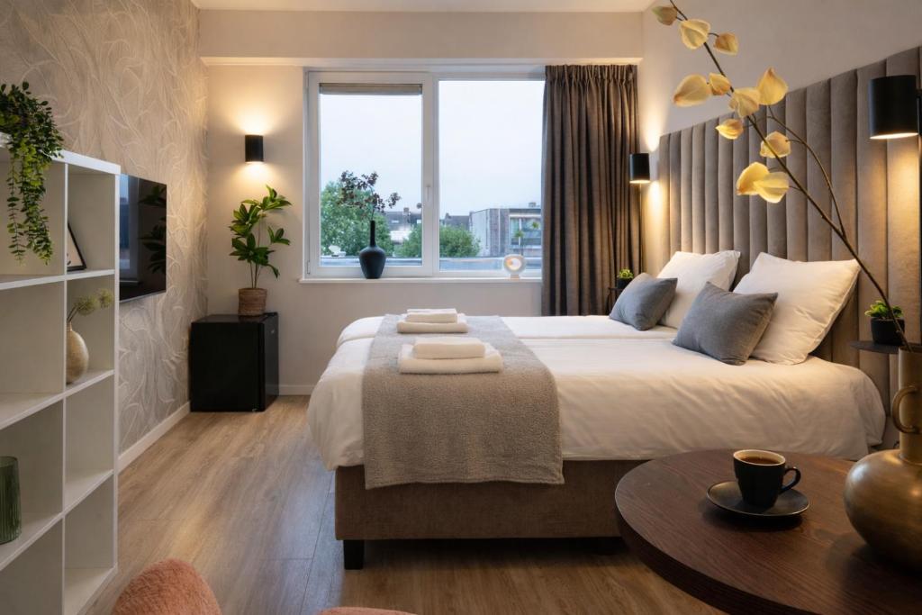 a bedroom with a large bed and a window at Vibrant Raamsdonksveer, near Efteling & Biesbosch in Raamsdonksveer
