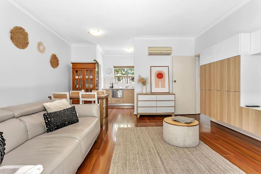 a living room with a couch and a table at Secure Suite in Gated Complex, Courtyard, 5 Min CBD in Rose Park