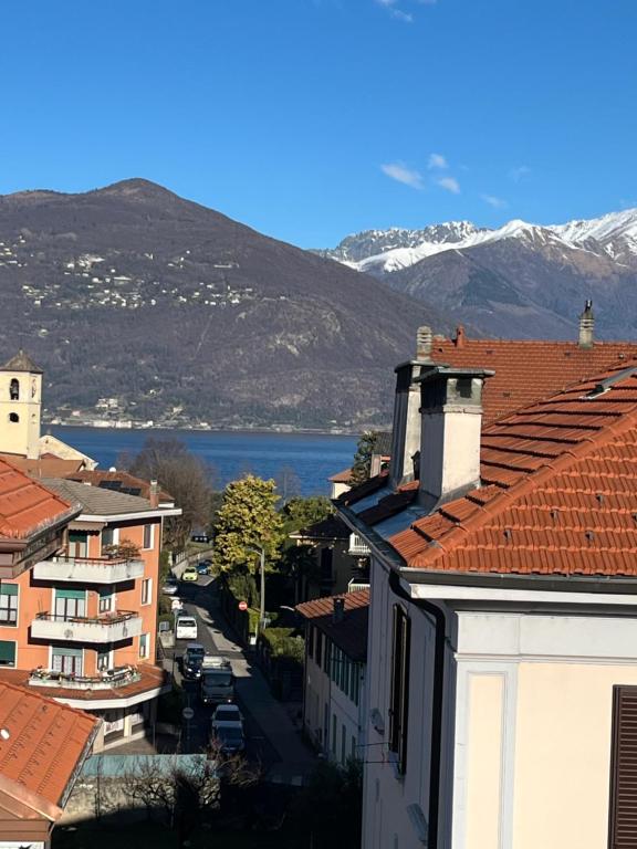 a view of a city with snow covered mountains at Relax Luino vista lago Casa LEA in Luino