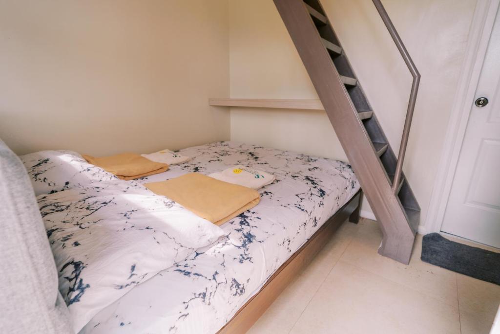 a bunk bed in a room with a ladder at Serenity Busay Room 3 in Cebu City