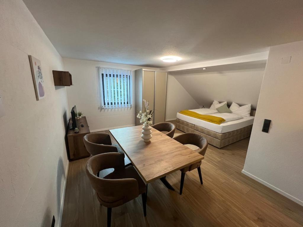 a room with a dining table and a bed at Allgäu Residenz & Spa in Wiggensbach