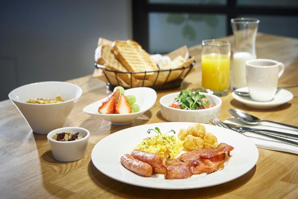 a table with a plate of breakfast foods and drinks at Hotelaround Forest in Pyeongchang