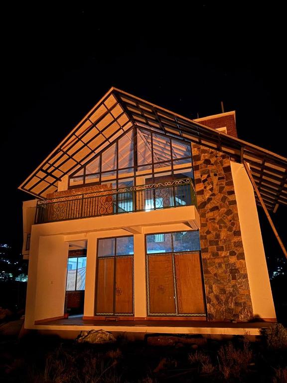 a building with glass windows on the side of it at Calmsutra retreat in Sānkhu