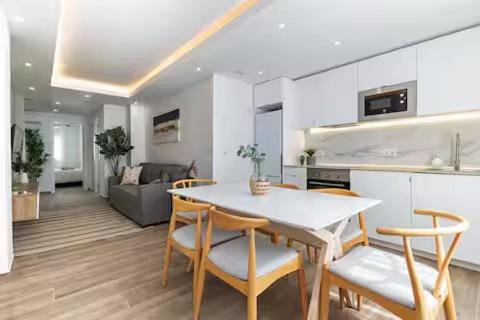 a kitchen and living room with a table and chairs at Monte Tulum in Torrent