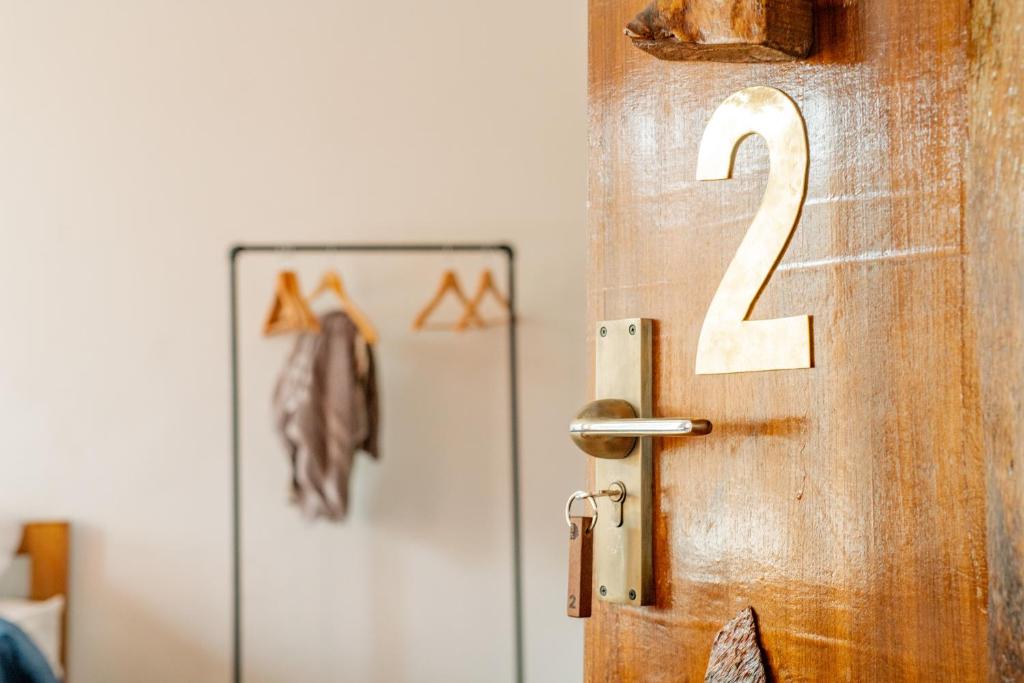 a wooden door with the number two on it at Ethico Retreat Formely Five14 BnB in Pātan