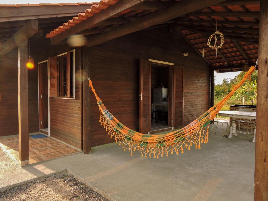 a hammock hanging from the side of a house at Casa De Praia Galheta in Farol de Santa Marta