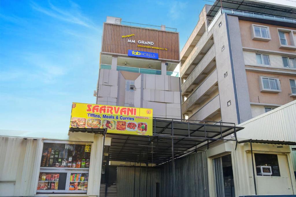 a building with a sign in front of a store at FabHotel SRP in Hyderabad