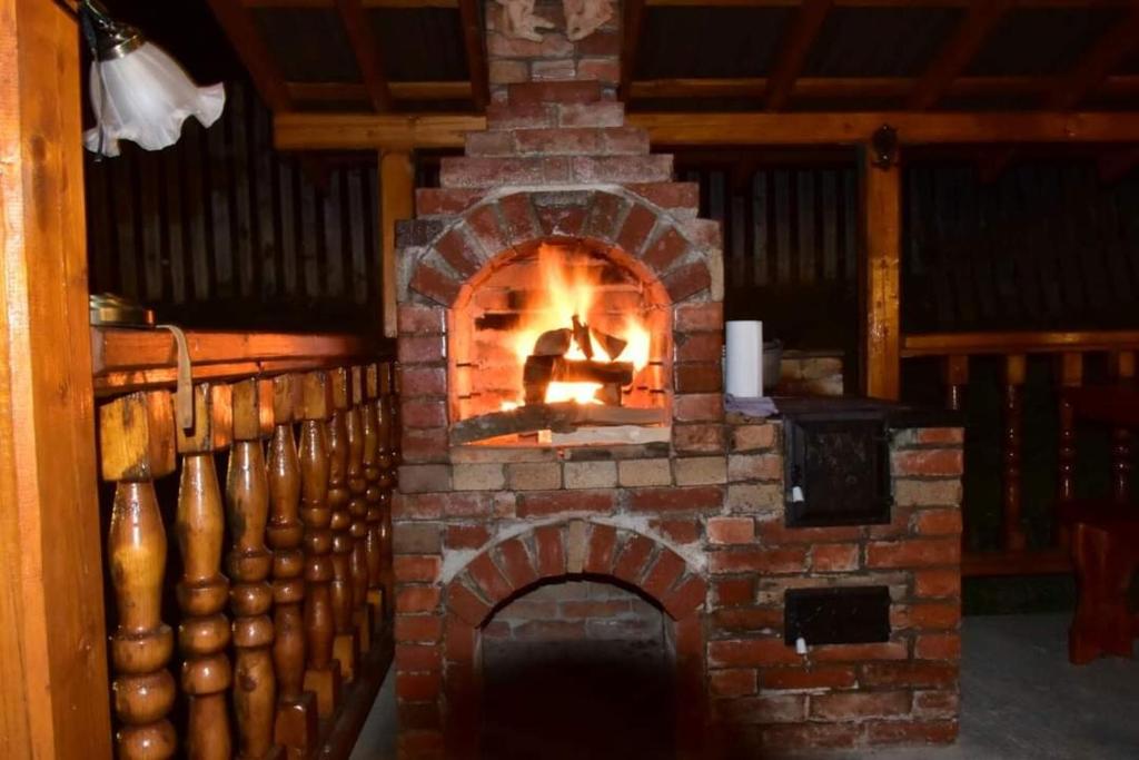 a brick oven with a fire in it at Casa DelCris in Pojorâta