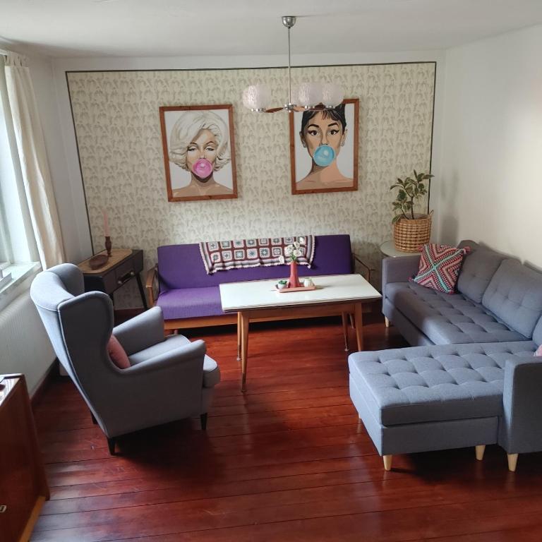 a living room with a couch and a table at Himmel in Ebensee