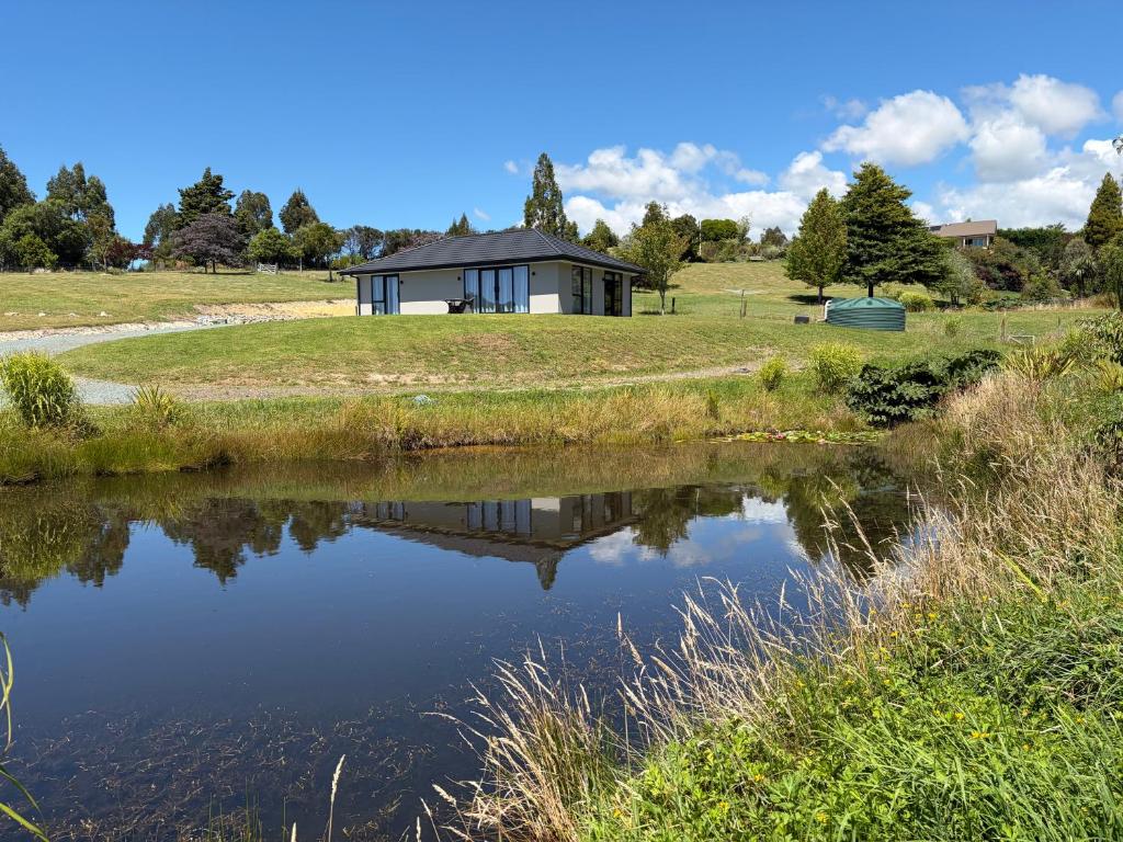 a house with a pond in front of it at The Cottage at 105 in Redwoods Valley